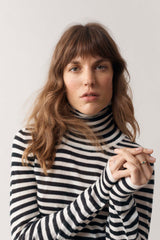 Close up of woman modelling our black and white stripe cashmere roll neck