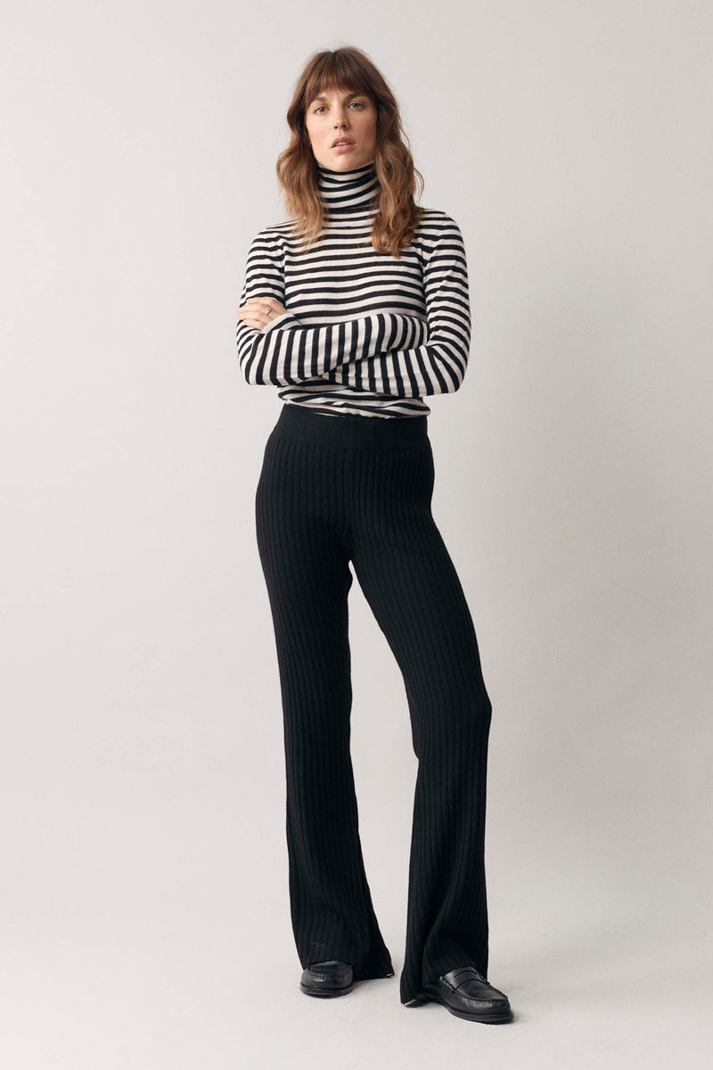 Woman modelling our black and white stripe cashmere roll neck