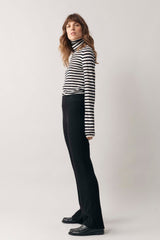 Side profile of woman modelling our black and white stripe cashmere roll neck