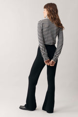Back profile of woman modelling our black and white stripe cashmere roll neck